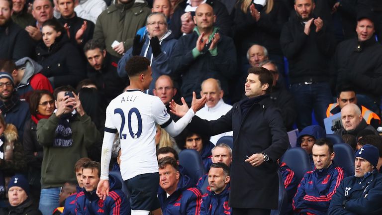 Dele Alli of Tottenham Hotspur shakes hands with Mauricio Pochettino manager of Tottenham Hotspur as he is substituted 