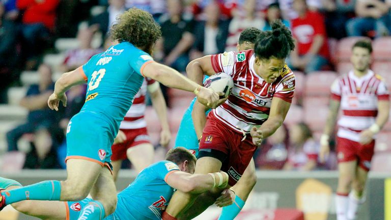 Wigan's Taulima Tautai is tackled by St Helens Joe Greenwood