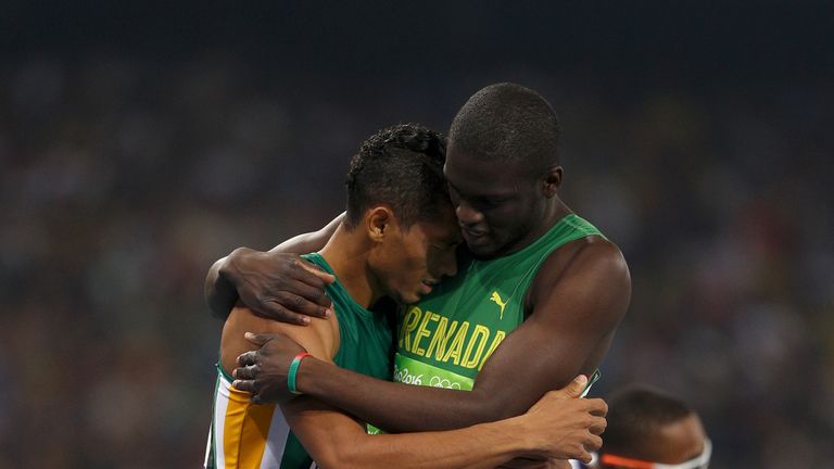 Wayde van Niekerk of South Africa celebrates with Kirani James of Grenada after breaking the 400m world record at Rio 2016