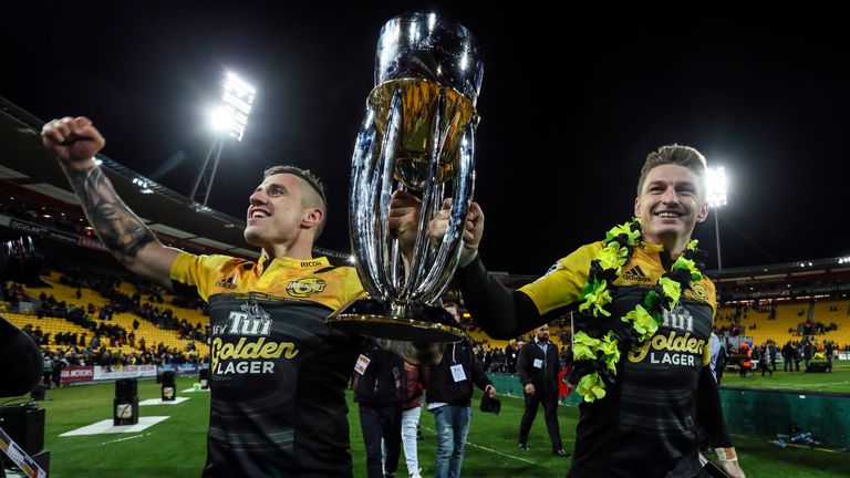   TJ Perenara and Beauden Barrett celebrate with the Super Rugby Trophy 