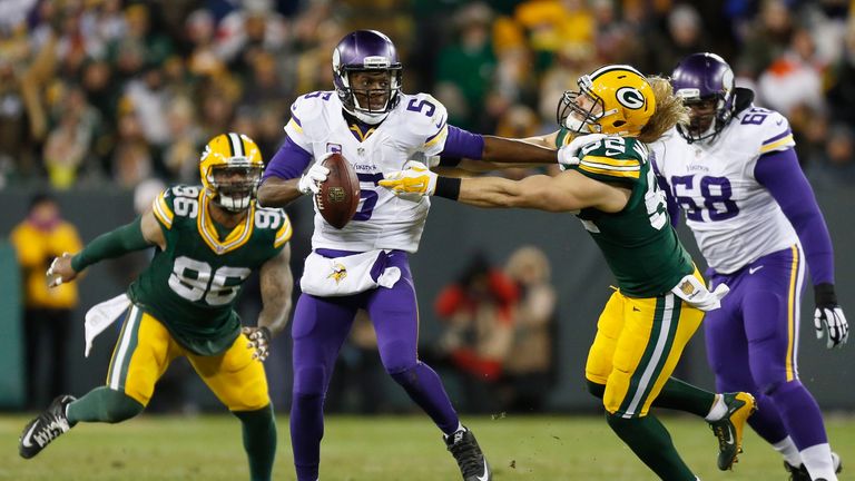 GREEN BAY, WI - JANUARY 03:  Teddy Bridgewater #5 of the Minnesota Vikings stiff arms Clay Matthews #52 of the Green Bay Packers during the second quarter 