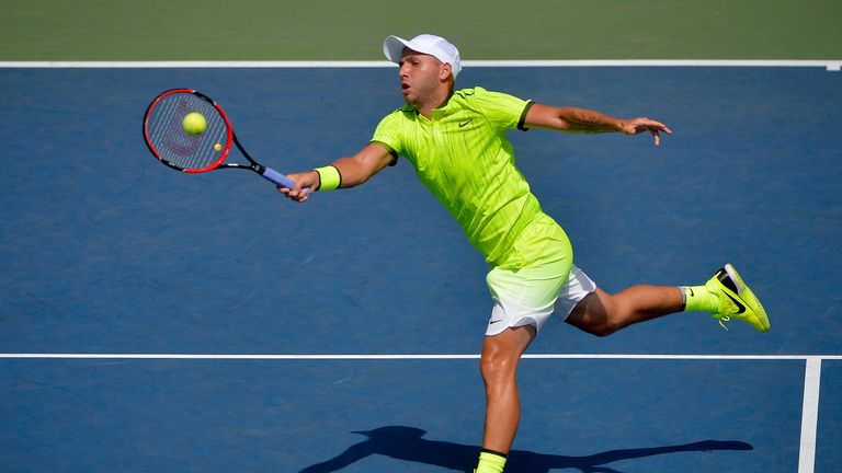 Daniel Evans of Great Britain returns a shot to Rajeev Ram of the United States