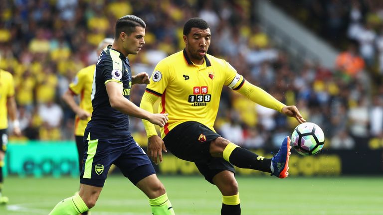 Troy Deeney of Watford controls the ball infront of Granit Xhaka 