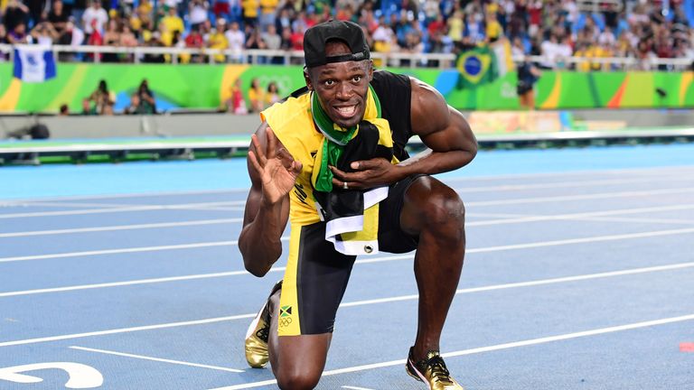 Jamaica's Usain Bolt holds up three fingers after completing the triple triple