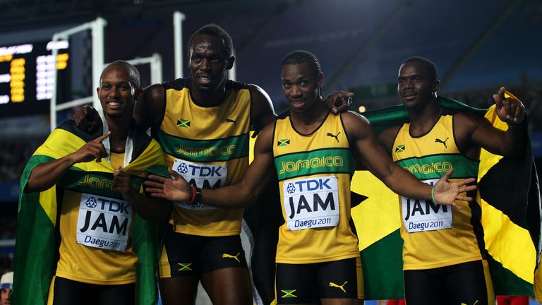 DAEGU, SOUTH KOREA - SEPTEMBER 04:   Michael Frater, Usain Bolt, Yohan Blake and Nesta Carter of Jamaica celebrate victory and a new world record in the me