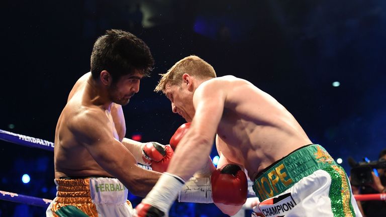 India's boxer Vijender Singh (L) fights with Australia's boxer Kerry Hope for the WBO Asia Pacific Super Middleweight title in New Delhi on July 16, 2016. 