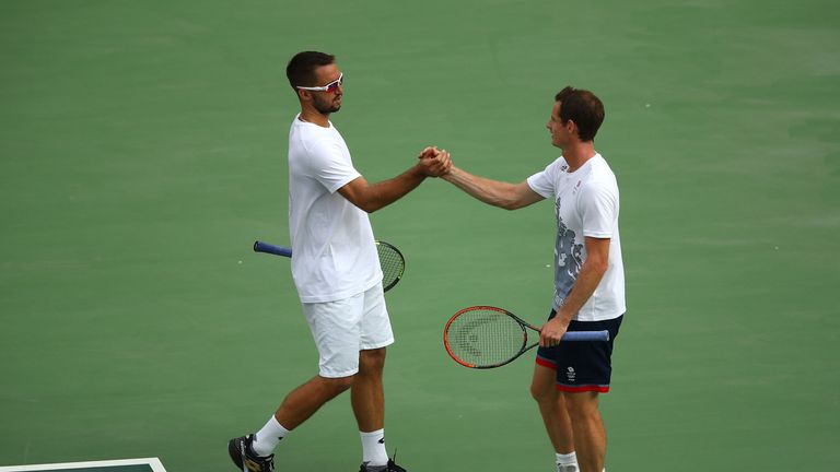 Murray greets Troicki during a practice session in Rio