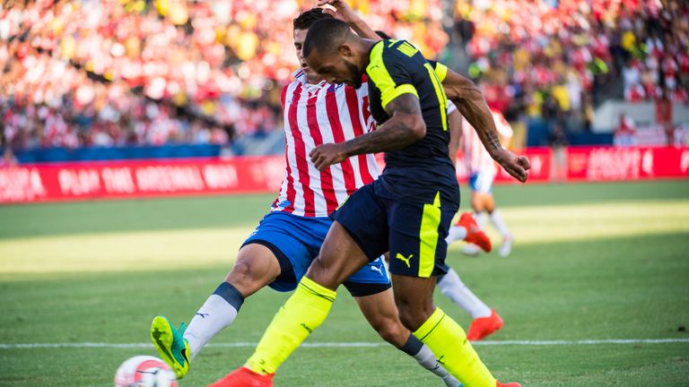 CARSON, CA - JULY 31: Theo Walcott #14 of Arsenal takes a shot on goal as Carlos Villaneuva #26 of CD Guadalajara defends during the friendly match between
