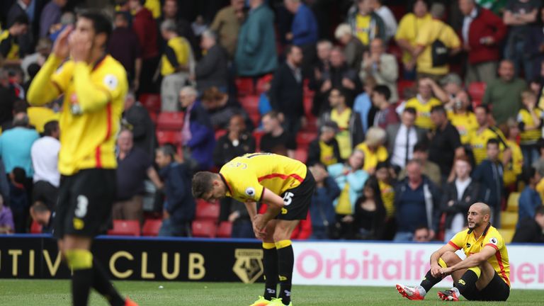 Nordin Amrabat of Watford looks dejected with his team mates at the final whistle during the match between Watford and Chelsea