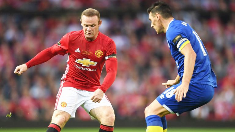 Manchester United striker Wayne Rooney takes on Everton's Gareth Barry