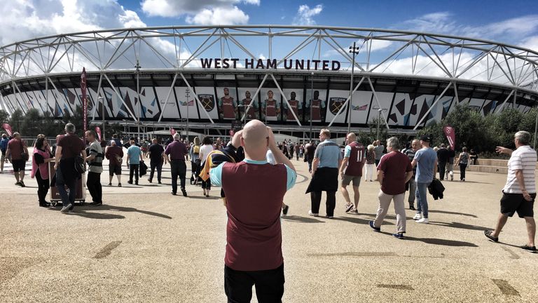 LONDON, ENGLAND - AUGUST 21: (EDITORS NOTE: This image was processed using digital filters) A West Ham fan takes a photo outside the stadium prior to the P