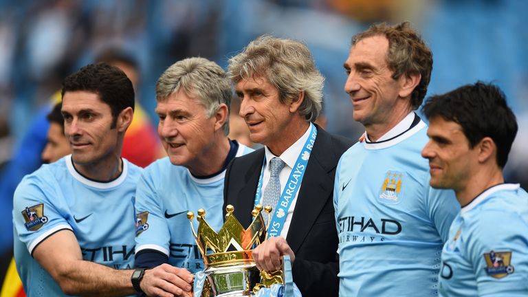 Manchester City goalkeeping coach Xabier Mancisidor, Brian Kidd, manager Manuel Pellegrini and Ruben Cousillas celebrate the club's title win 