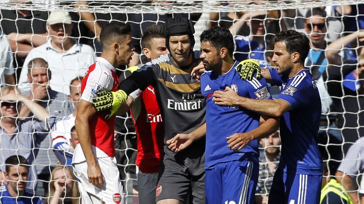 Arsenal's Brazilian defender Gabriel (L) and Chelsea's Brazilian-born Spanish striker Diego Costa (2nd R) are separated by Arsenal's Czech goalkeeper Petr 