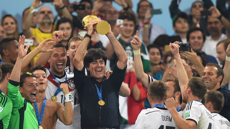 RIO DE JANEIRO, BRAZIL - JULY 13:  Joachim Loew of Germany lifts the World Cup trophy with his team after defeating Argentina 1-0 in extra time during the 