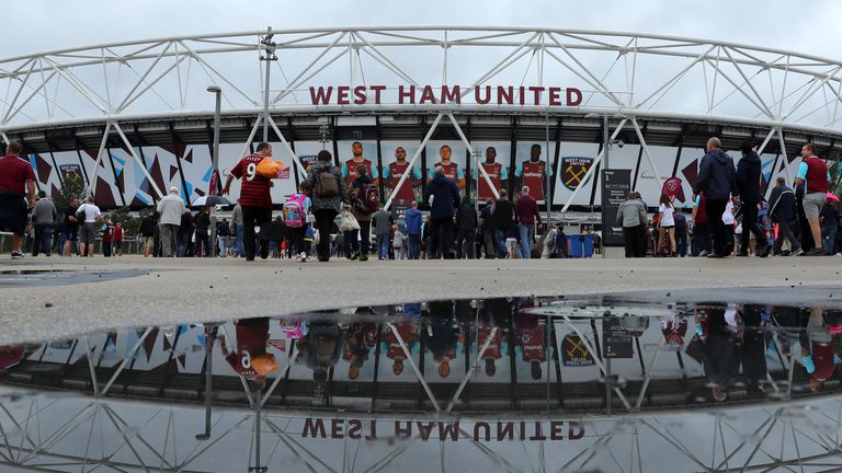Spectators walk to the stadium ahead of the game against Watford