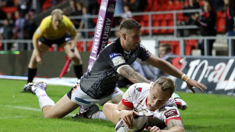 St Helens' Adam Swift goes over for a try