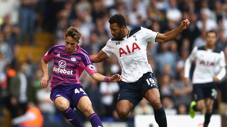 Adnan Januzaj of Sunderland (L) is put under pressure from Tottenham's Mousa Dembele 