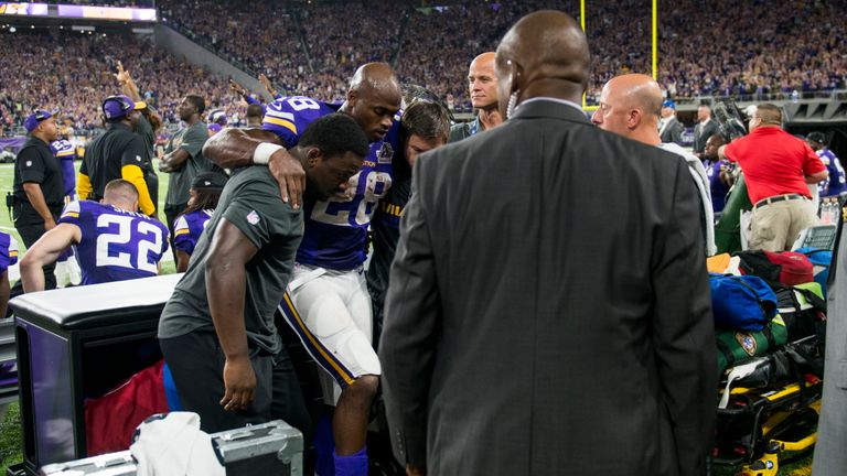 MINNEAPOLIS, MN - SEPTEMBER 18: Adrian Peterson #28 of the Minnesota Vikings is carried into the locker room after injuring his knee in the third quarter o