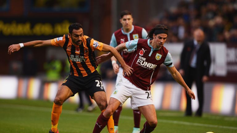 BURNLEY, ENGLAND - NOVEMBER 08:  George Boyd of Burnley holds off Ahmed Elmohamady of Hull City during the Barclays Premier League match between Burnley an
