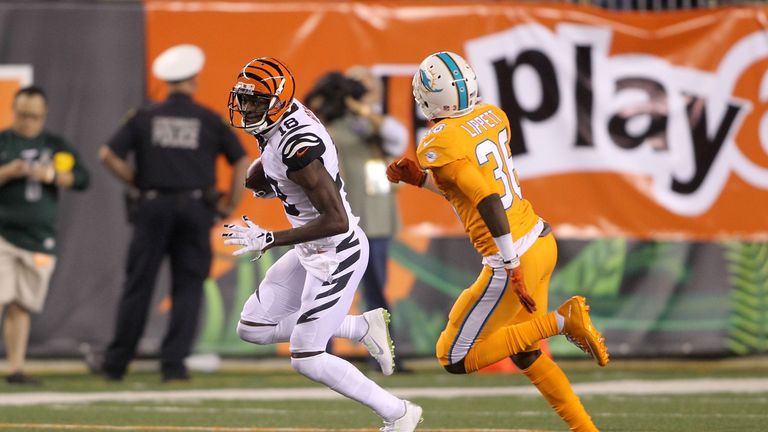 CINCINNATI, OH - SEPTEMBER 29:  A.J. Green #18 of the Cincinnati Bengals attempts to run the ball past Tony Lippett #36 of the Miami Dolphins during the se