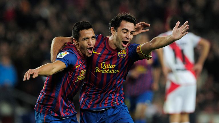 Barcelona's Chilean forward Alexis Sanchez (L) celebrates with teammate Barcelona's midfielder Xavi Hernandez (R) after scoring during the Spanish league f