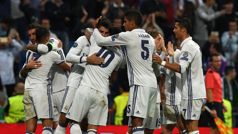 Real Madrid's forward Alvaro Morata is congratulated by his teammates after scoring during the UEFA Champions League football match Real Madrid CF vs Sport