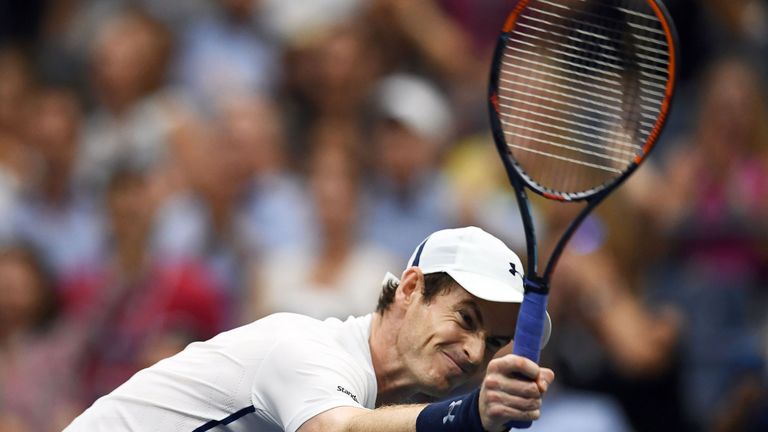 Andy Murray of Britain hits the net with his racket in dejection after losing a game against Kei Nishikori of Japan during their 2016 US Open Mens Singles 