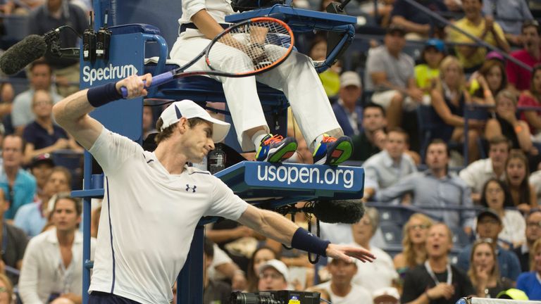 TOPSHOT - Andy Murray of Great Britain smashes his racket on the net while playing against Kei Nishikori of Japan during their 2016 US Open men's singles q