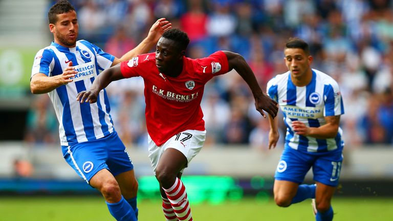 Andy Yiadom of Barnsley battles for the ball with Tomer Hemed and Anthony Knockaert of Brighton
