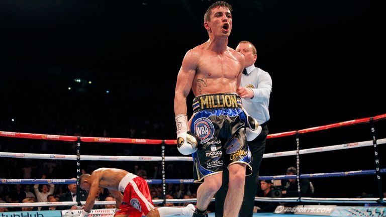 Anthony Crolla (right) walks back to his corner after knocking down Ismael Barroso during the WBA World Lightweight Title bout at the Manchester Arena.