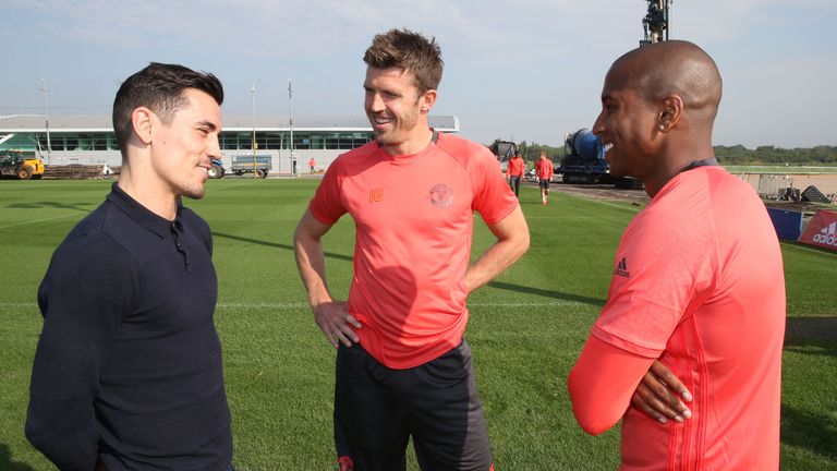 Boxer Anthony Crolla chats to Ashley Young (R) and Michael Carrick of Manchester United during a Manchester United training session