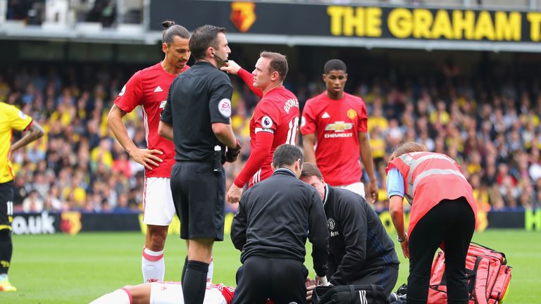 WATFORD, ENGLAND - SEPTEMBER 18: Anthony Martial of Manchester United is treated by the Manchester United medial staff  during the Premier League match bet
