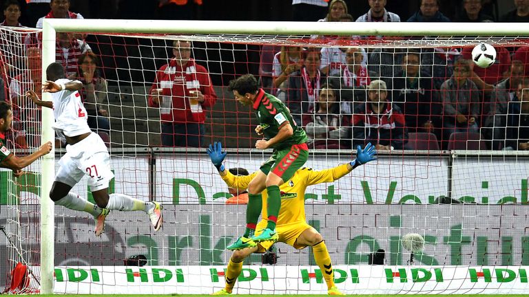 Cologne's French striker Anthony Modeste (L) scores against Freiburg´s goalkeeper Alexander Schwolow during the German first division Bundesliga football 