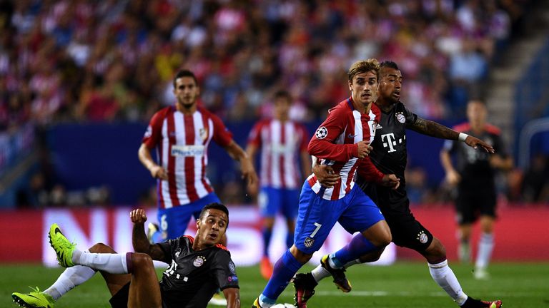 Antoine Griezmann of Atletico Madrid battles for the ball with Arturo Vidal and Thiago of Bayern Munich