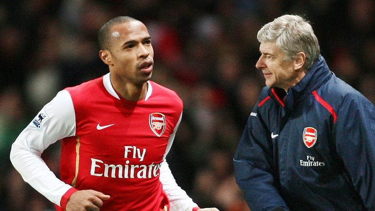 Arsenal's Thierry Henry (L) runs past Manager Arsene Wenger (R) while celebrating scoring the winning goal against Manchester United during the Premiership