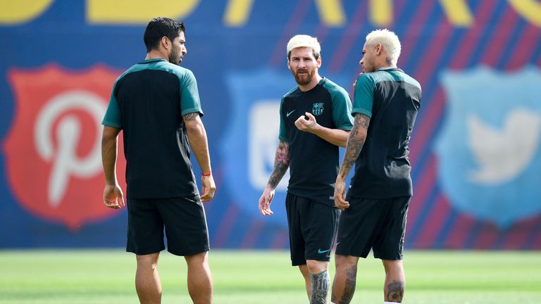 (L-R) Luis Suarez, Neymar Jr. and Lionel Messi talk amongst themselves during training