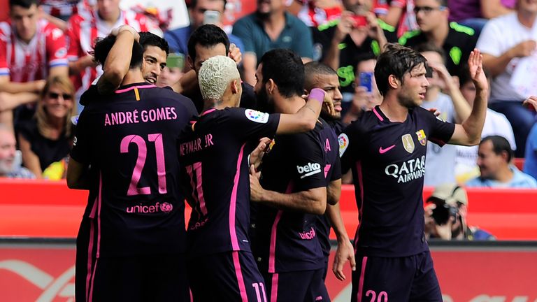 Barcelona forward Luis Suarez (2nd L) celebrates a goal against Sporting Gijon