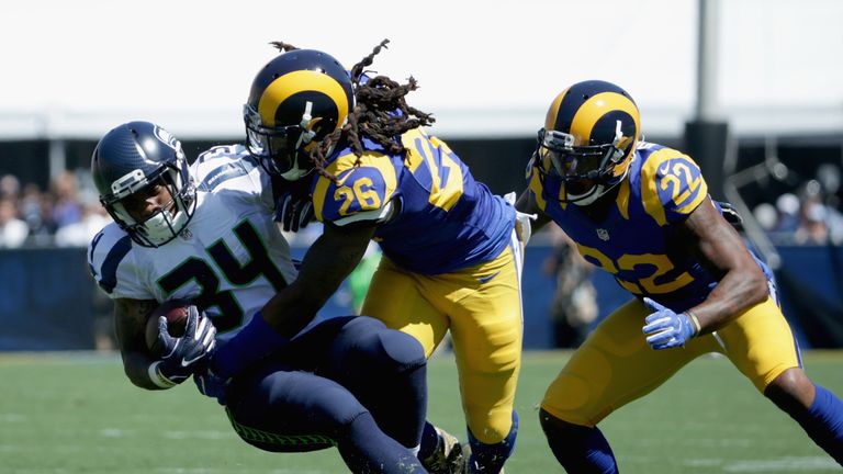 LOS ANGELES, CA - SEPTEMBER 18:   Mark Barron #26 of the Los Angeles Rams tackles  Thomas Rawls #34 of the Seattle Seahawks in front of teammate Trumaine J