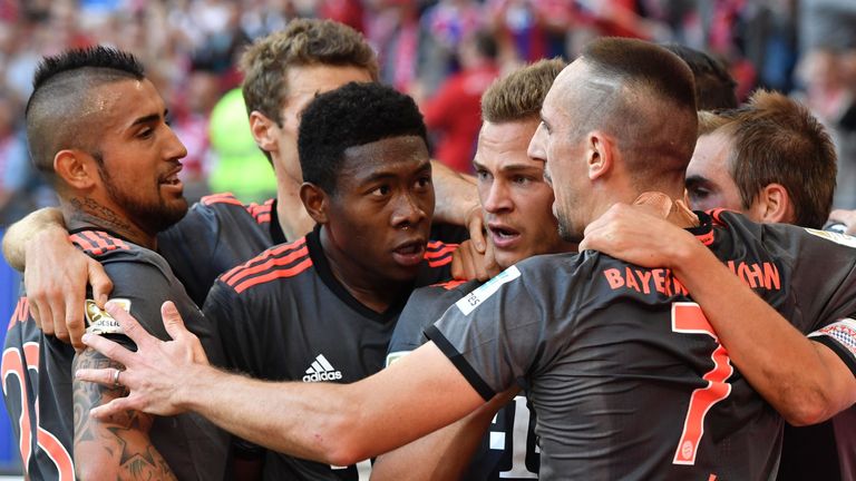 Bayern Munich's midfielder Joshua Kimmich (C) celebrates scoring with his team-mates