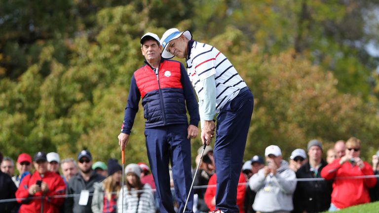 Bill Murray (right) holes a putt for the American side