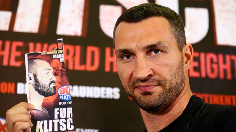 Wladimir Klitschko poses with an image of Tyson Fury after he failed to appear at a press conference