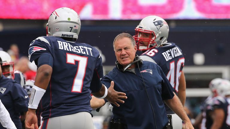 FOXBORO, MA - SEPTEMBER 18:  Head coach Bill Belichick of the New England Patriots high fives Jacoby Brissett #7 during the second half against the Miami D