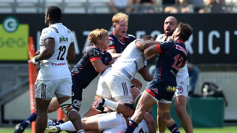 Grenoble's and Brive's players fight during their French Top 14 rugby union match