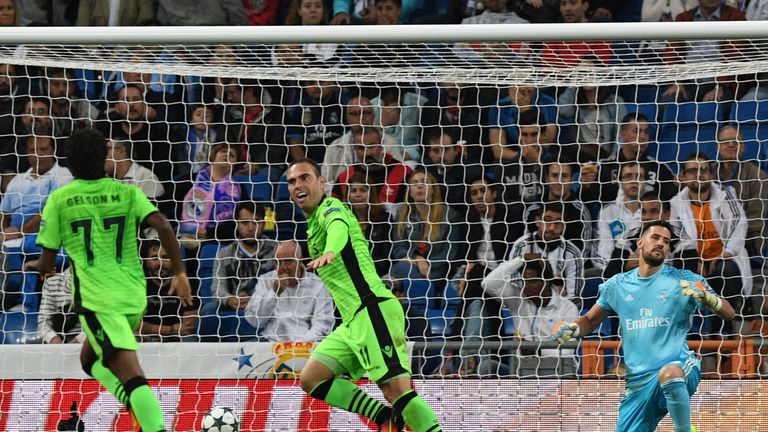 Sporting's Brazilian midfielder Bruno Cesar (C) reacts after scoring the opener against Real Madrid