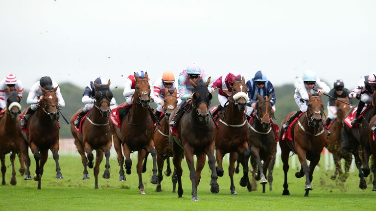 Captain Colby (blinkered) comes home clear of a bunch finish for the Portland Handicap on St Leger day at Doncaster.