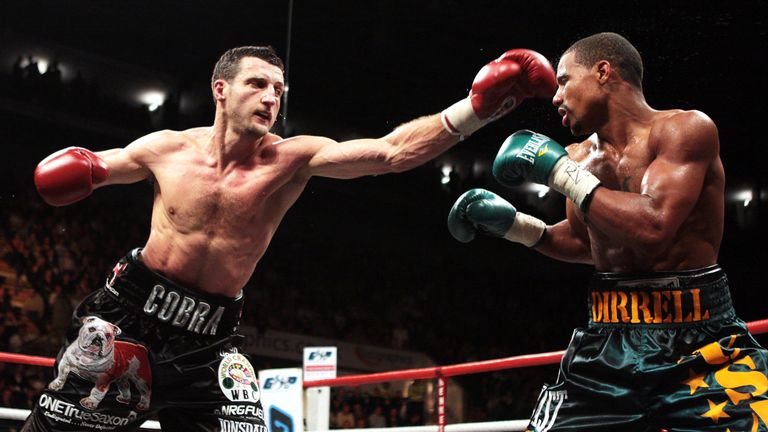 Carl Froch (L) connects with a left jab on way to retaining the WBC Super Middleweight title