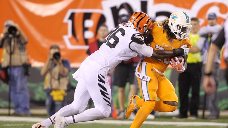 CINCINNATI, OH - SEPTEMBER 29:  Carlos Dunlap #96 of the Cincinnati Bengals tackles Jay Ajayi #23 of the Miami Dolphins during the second quarter at Paul B