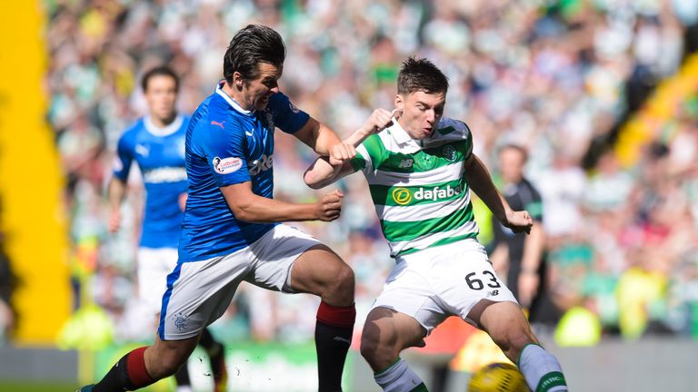 Rangers' Joey Barton (L) challenges Kieran Tierney of Celtic