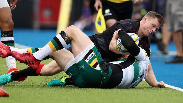 BARNET, ENGLAND - SEPTEMBER 17:  George North of Northampton is tackled by Chris Ashton during the Aviva Premiership match between Saracens and Northampton