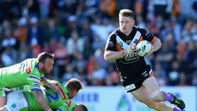 Chris Lawrence of the Tigers makes a break against the Canberra Raiders